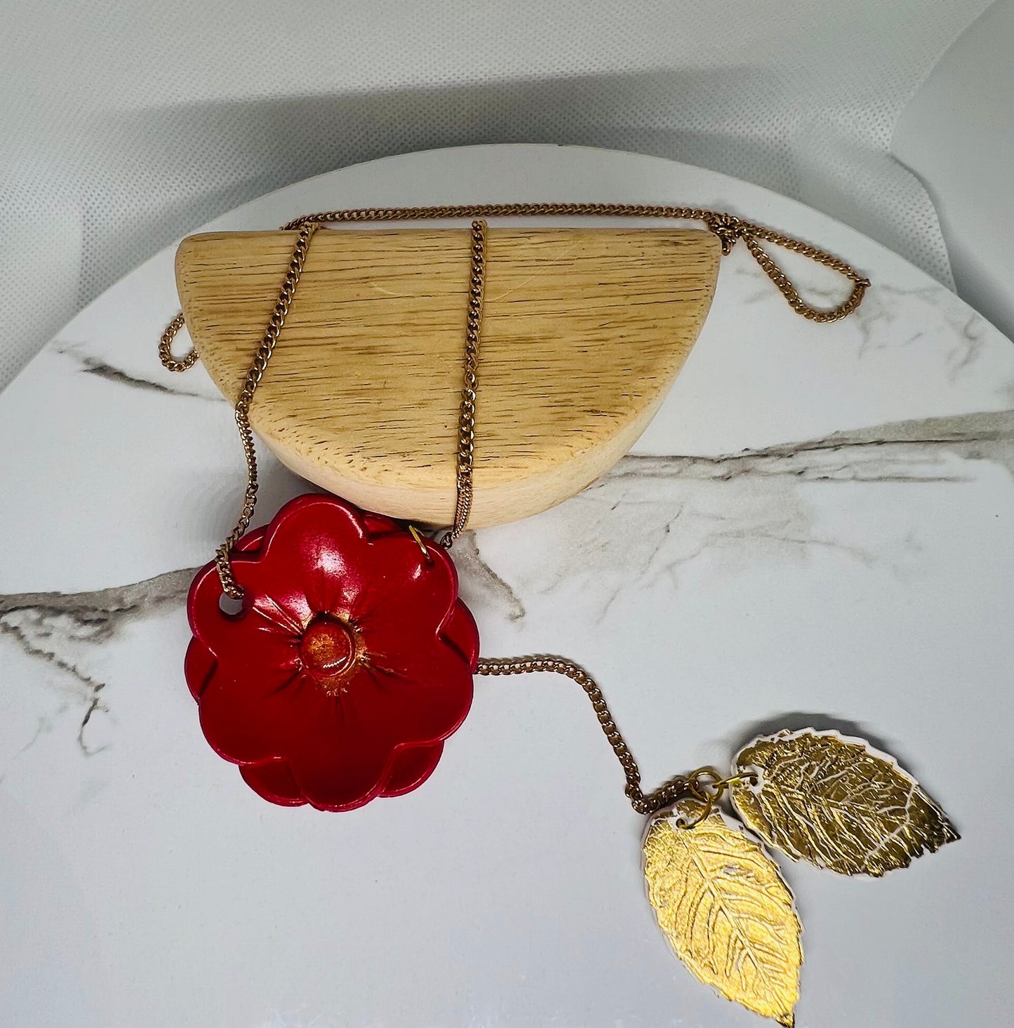 Red flower with gold leaf necklace