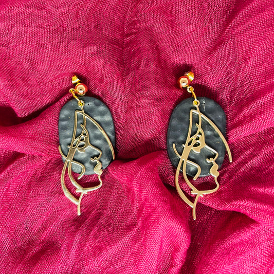 Gold face earrings